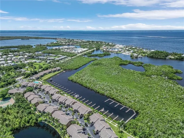 Birds eye view of property with a water view