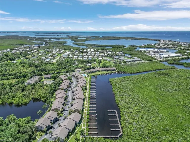 Birds eye view of property with a water view
