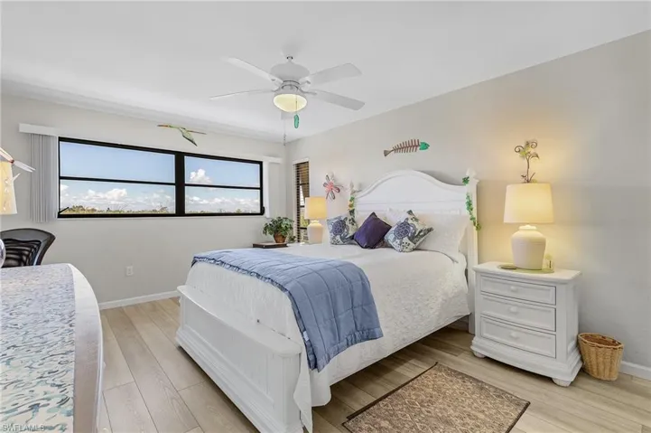 Bedroom with ceiling fan and light wood-type flooring