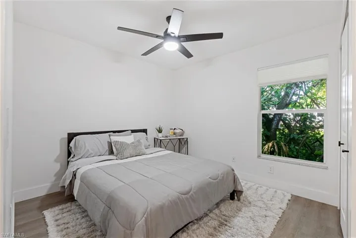 Bedroom with ceiling fan and hardwood / wood-style flooring