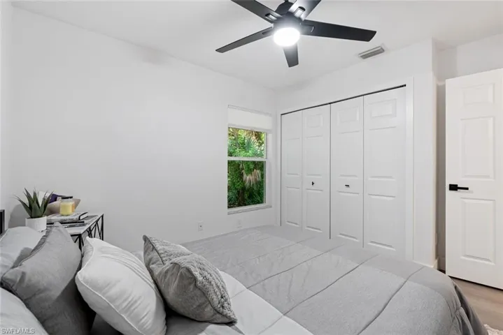 Bedroom with wood-type flooring, a closet, and ceiling fan