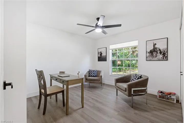 Office space with light wood-type flooring and ceiling fan