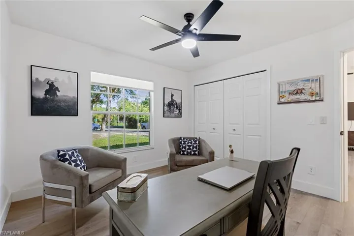 Office area featuring light hardwood / wood-style flooring and ceiling fan
