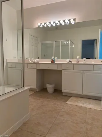 Bathroom with a shower with door and vanity