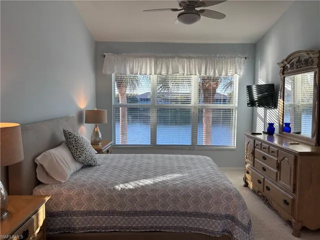 Bedroom featuring ceiling fan and light carpet