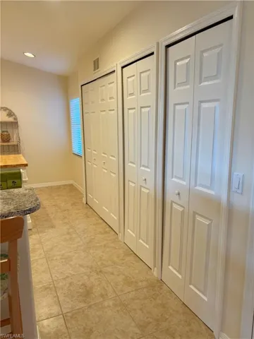 Hall featuring light tile patterned floors