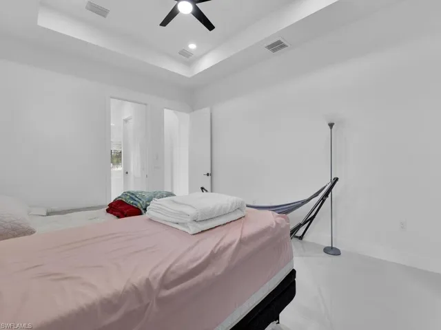 Bedroom featuring ceiling fan and a raised ceiling