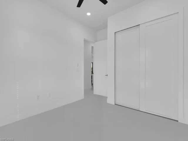 Unfurnished bedroom featuring ceiling fan and a closet