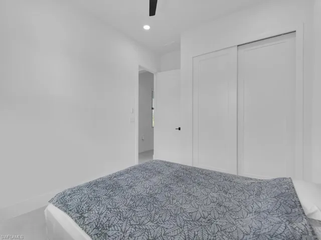 Bedroom featuring ceiling fan and a closet