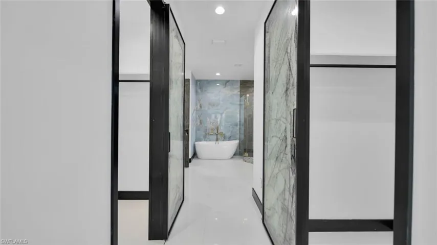Full bathroom with recessed lighting and a freestanding bath