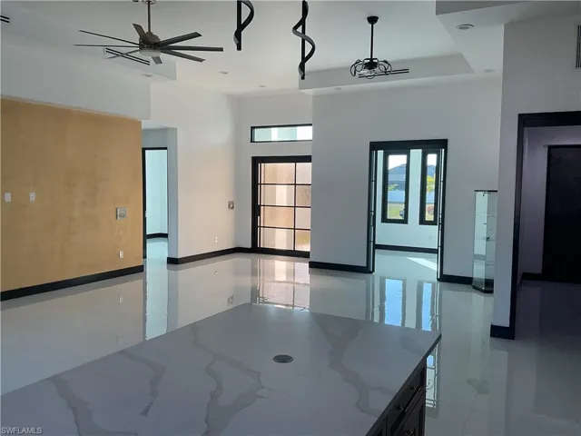 Spare room featuring a ceiling fan and a high ceiling