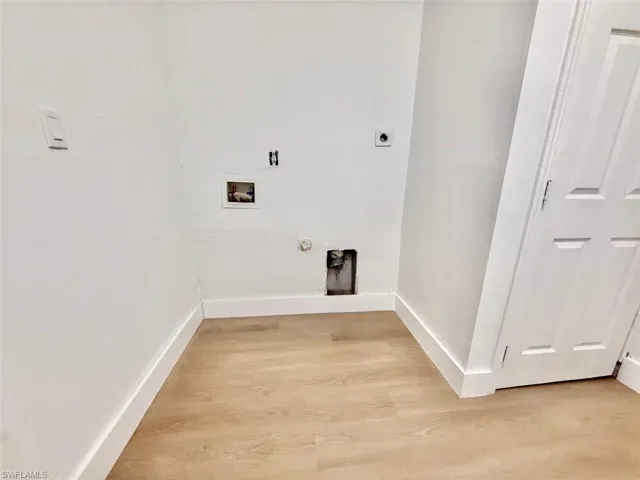 Laundry room with gas dryer hookup, hookup for a washing machine, electric dryer hookup, and hardwood / wood-style floors