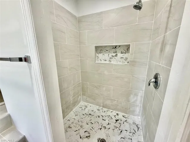 Bathroom featuring tiled shower