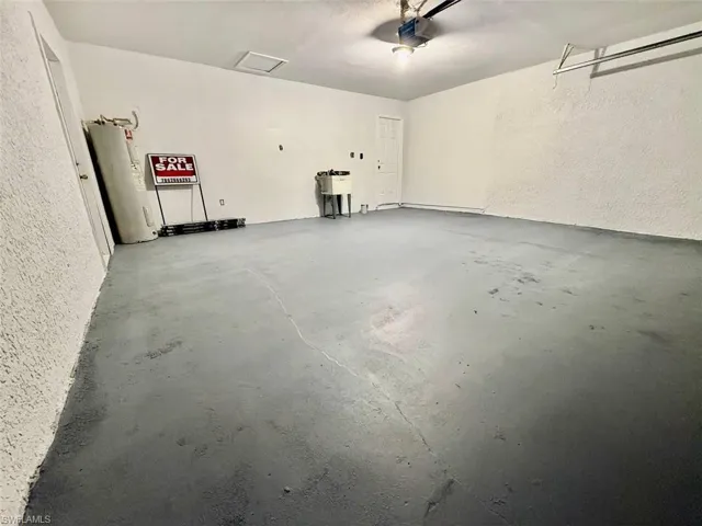 Garage with a garage door opener and electric water heater