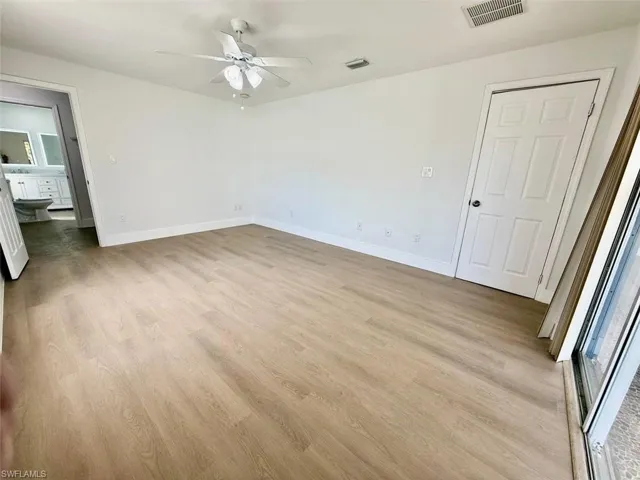 Unfurnished bedroom with ceiling fan, light wood-type flooring, and multiple windows