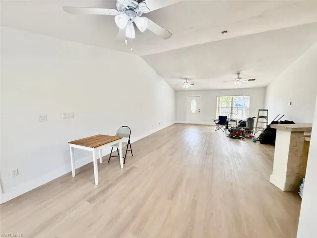 Miscellaneous room featuring ceiling fan, light hardwood / wood-style flooring, and vaulted ceiling