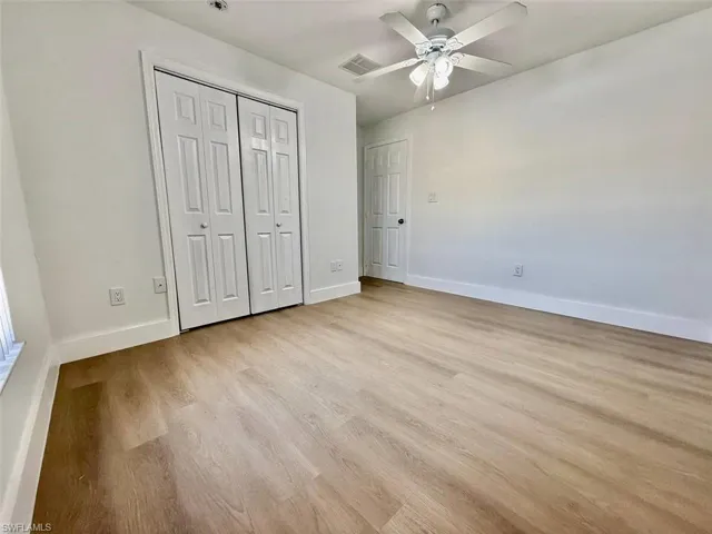 Unfurnished bedroom featuring ceiling fan, light hardwood / wood-style floors, and a closet