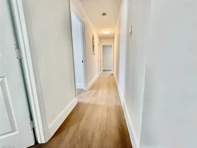 Corridor featuring light wood-type flooring
