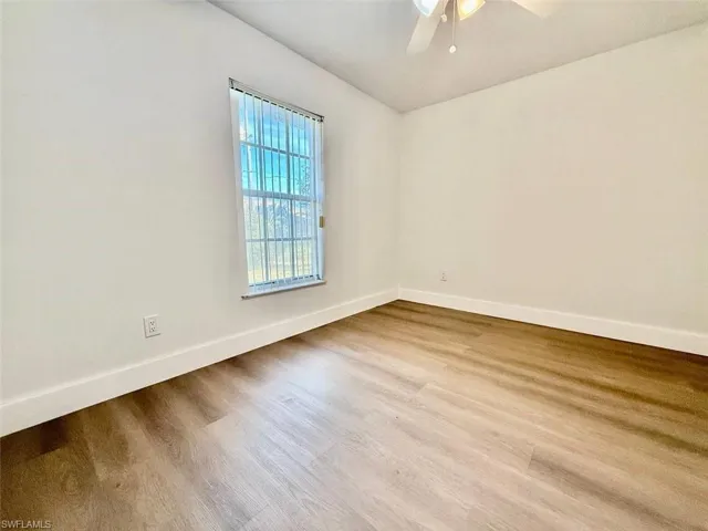 Spare room featuring ceiling fan and hardwood / wood-style flooring