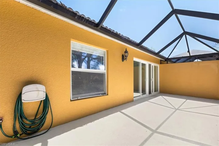 Back of house featuring a lanai and a patio
