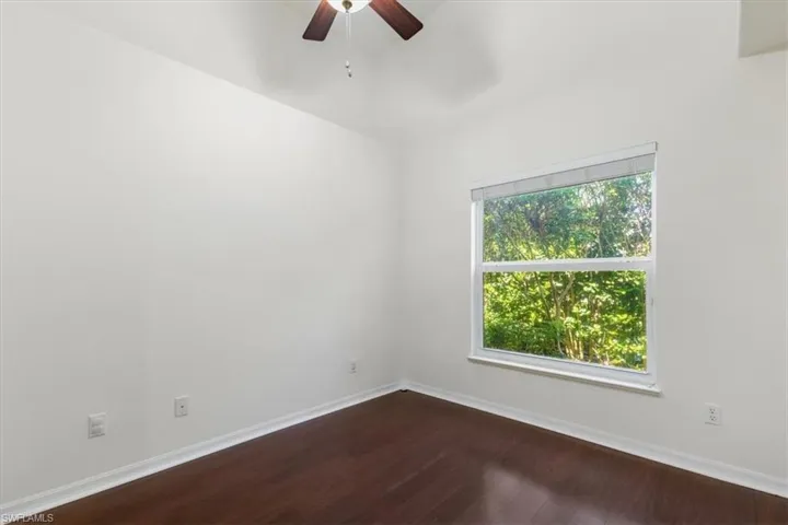 Unfurnished room featuring ceiling fan and hardwood / wood-style floors