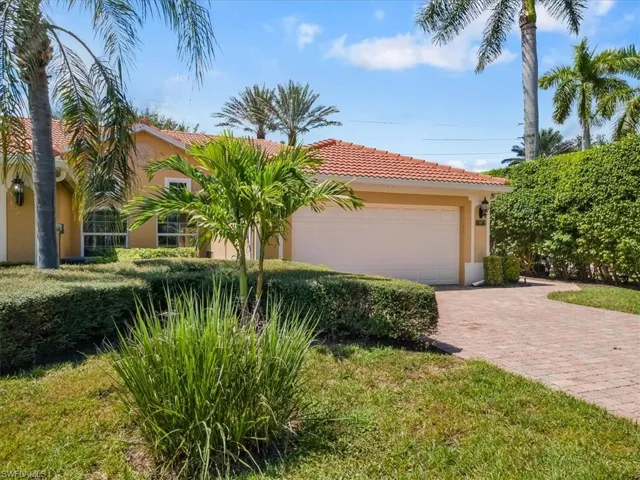 Mediterranean / spanish house with a front lawn and a garage