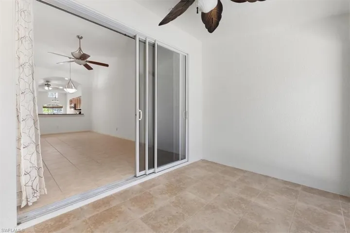 Tiled empty room with ceiling fan