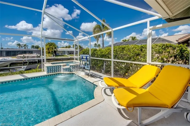 Combined pool / hot tub featuring a sunroom, a lanai, and a patio