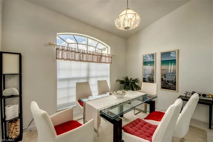 Dining room with suspended lighting and vaulted ceiling