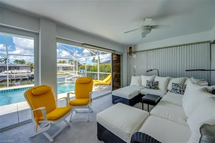 Living area with a sunroom and a ceiling fan