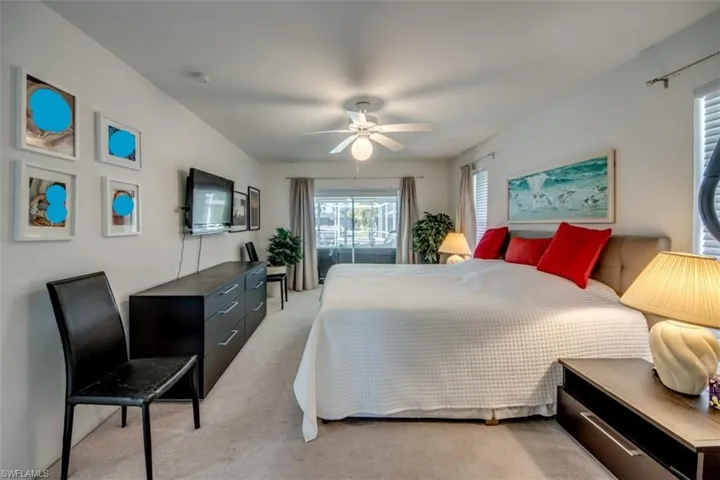 Bedroom featuring light carpet and ceiling fan