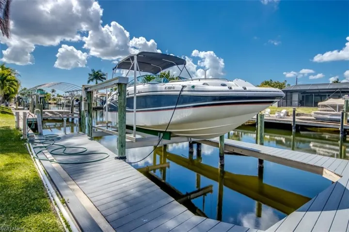 Dock featuring boat lift and a water view