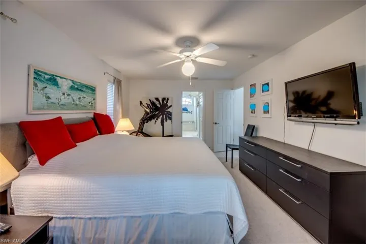 Bedroom featuring light colored carpet and ceiling fan