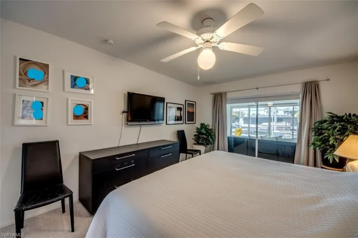 Bedroom featuring light colored carpet and a ceiling fan