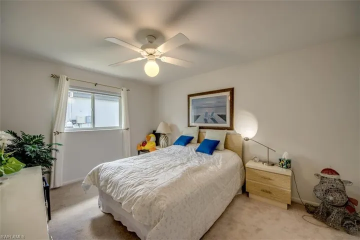 Bedroom featuring light carpet and a ceiling fan