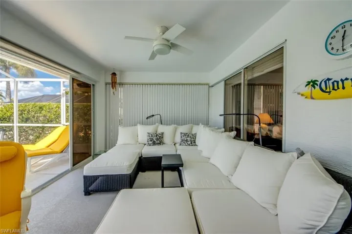 Sunroom / solarium with a ceiling fan and outdoor furniture