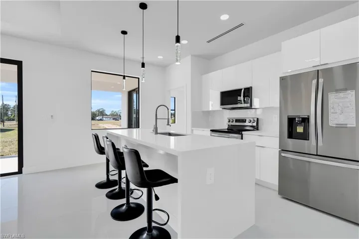Kitchen featuring appliances with stainless steel finishes, a sink, plenty of natural light, and recessed lighting