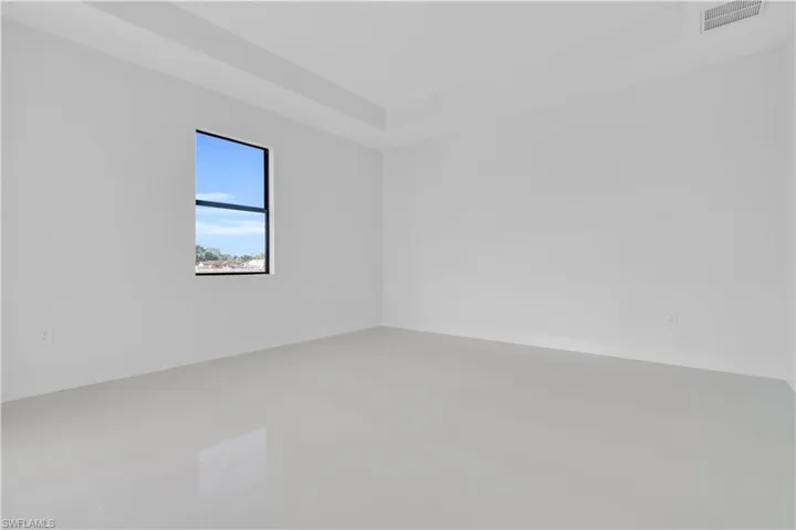 Unfurnished room featuring visible vents