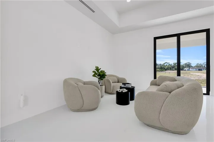 Living area with baseboards and visible vents