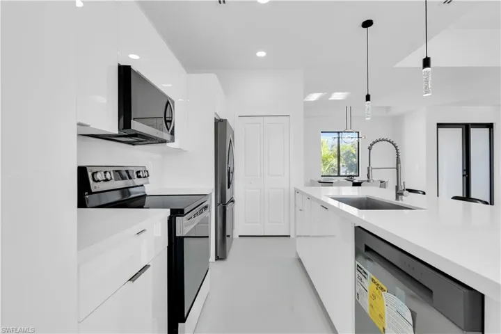 Kitchen featuring a sink, modern cabinets, and stainless steel appliances