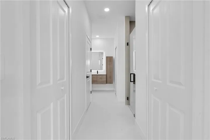 Corridor with visible vents and recessed lighting