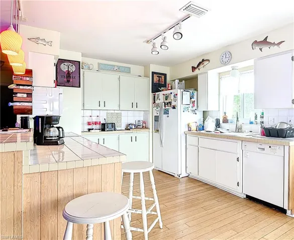 Kitchen featuring backsplash, tile counters