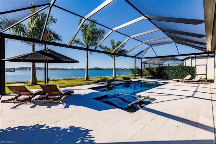 Luxury Pool Area w/ Travertine Deck & Waterfalls Overlooking 240 Acre Lake