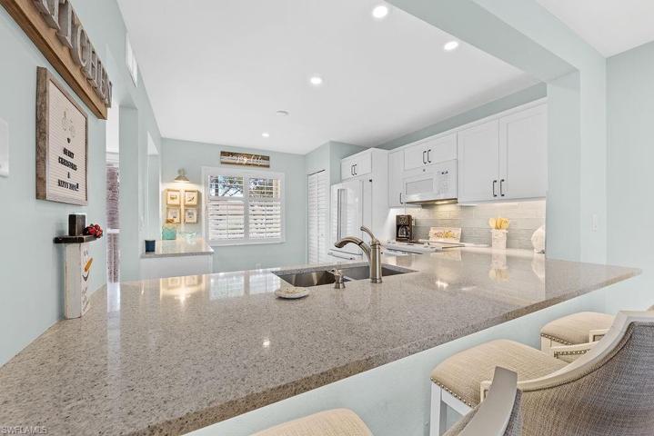 Oversized one level counter top, chairs on the opposite side for people to sit and converse with the cooks!