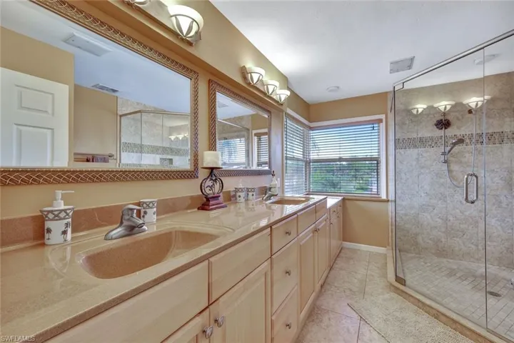 Upper level Master Bathroom features dual sinks, an enormous tiled shower, and lots of natural light.