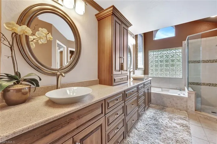 Sumptuously appointed first floor Master Bathroom has dual sinks, soaking tub, and a large shower.