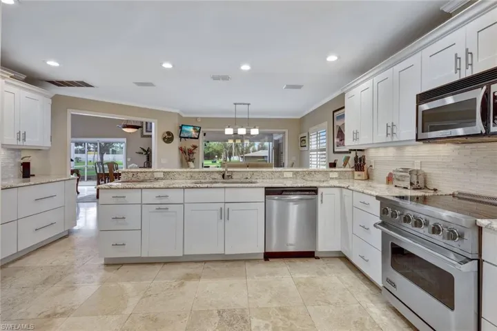 You'll love the open Kitchen with granite counters, raised-paned wood cabinets, and high-end appliances.