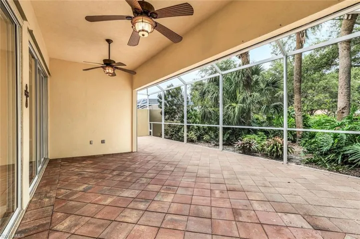 Unfurnished sunroom featuring ceiling fan