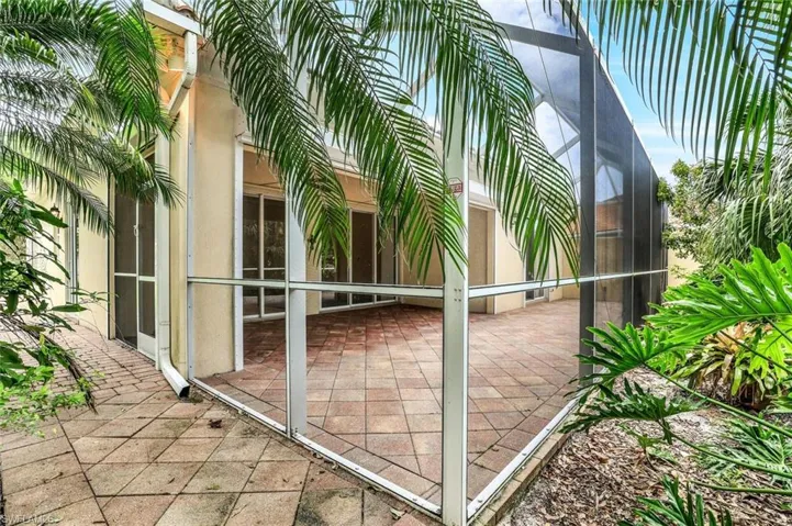View of patio featuring glass enclosure