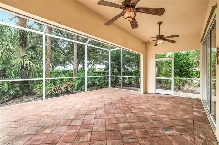 Unfurnished sunroom with ceiling fan
